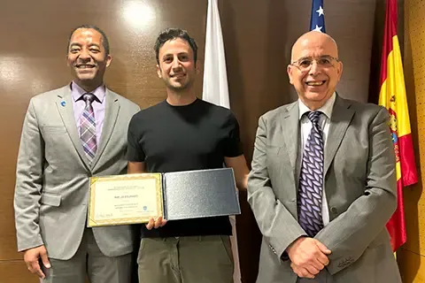 Gregory Triplett, Ph.D., Dean of <a href='http://9my.safarinautique.com'>博彩网址大全</a>'s School of Science and Engineering, traveled to Madrid to personally congratulate and present the honor to Charles El Mir, Ph.D.